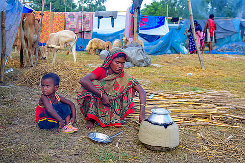 A woman cooks at a flood shelter